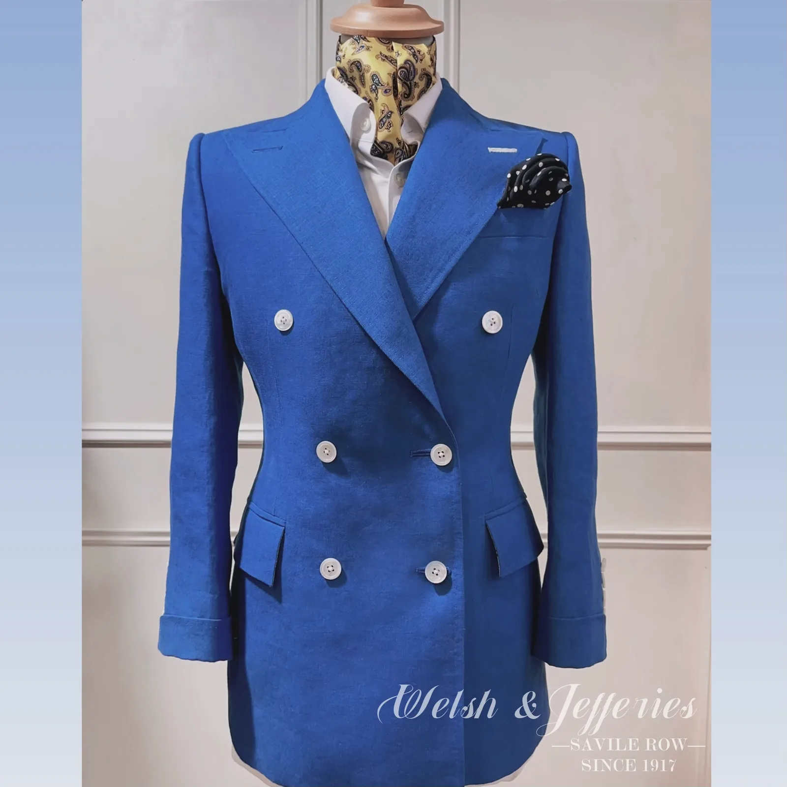 Front view of electric-blue double-breasted ladies' three-piece suit.