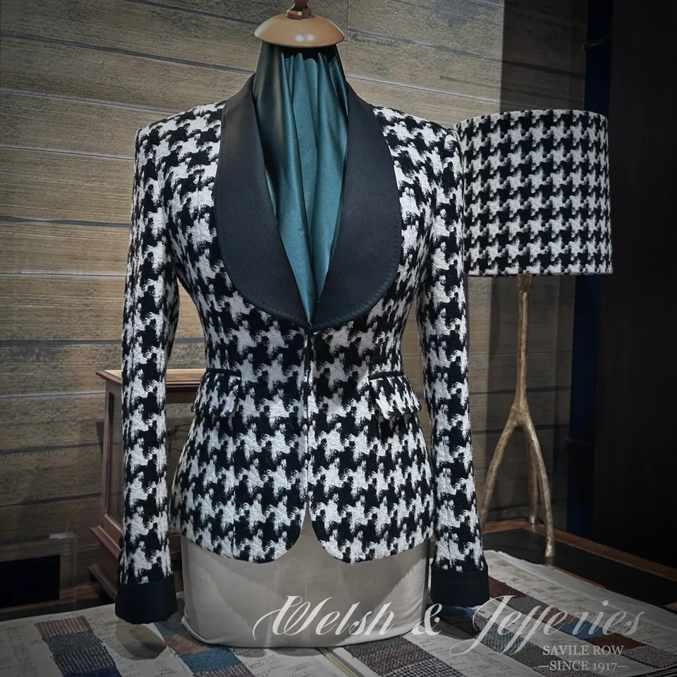 Front view of black-and-ivory houndstooth ladies' jacket with a black shawl collar.