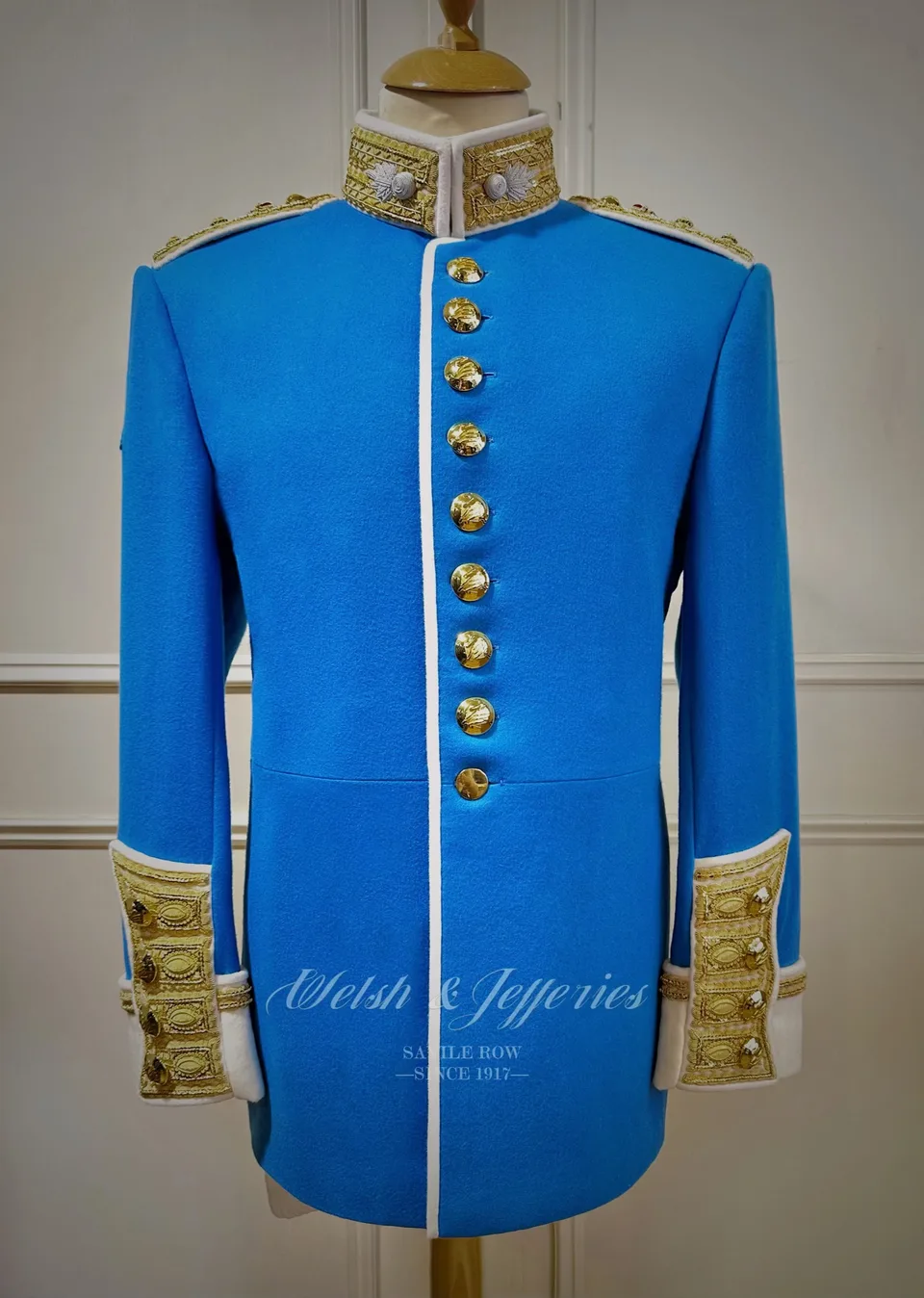 Cerulean ceremonial tunic with ivory collar, white piping, gilt buttons and gold-bullion cuffs.