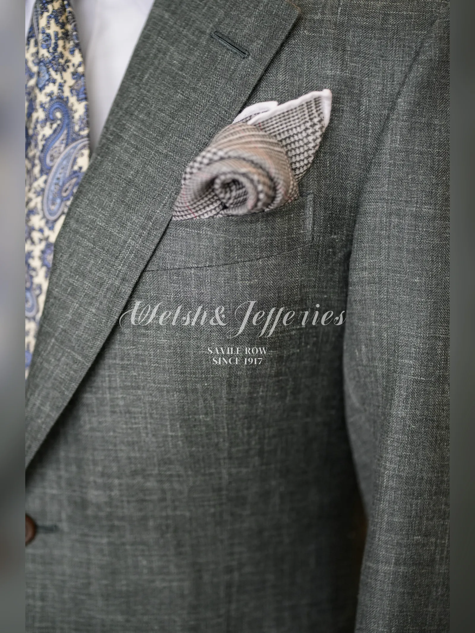 Close view of the pocket work on a moss-grey crosshatch summer jacket