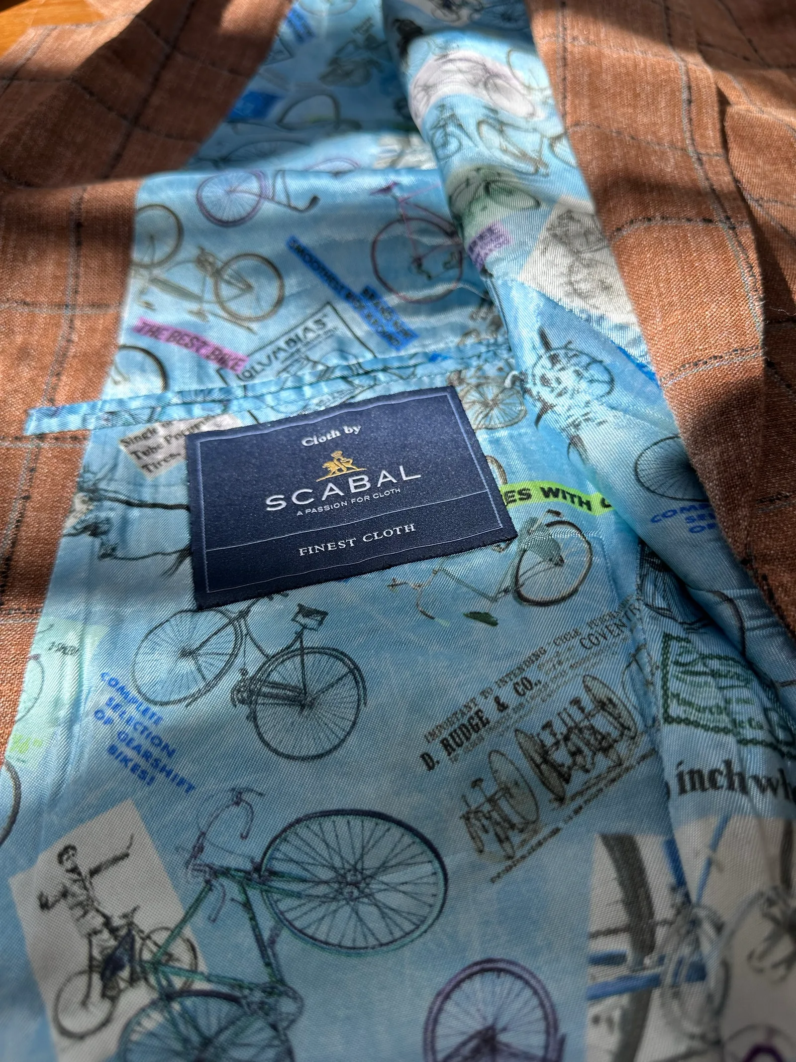 内里一瞥：浅蓝单车地图插画里布与 Scabal 标签。