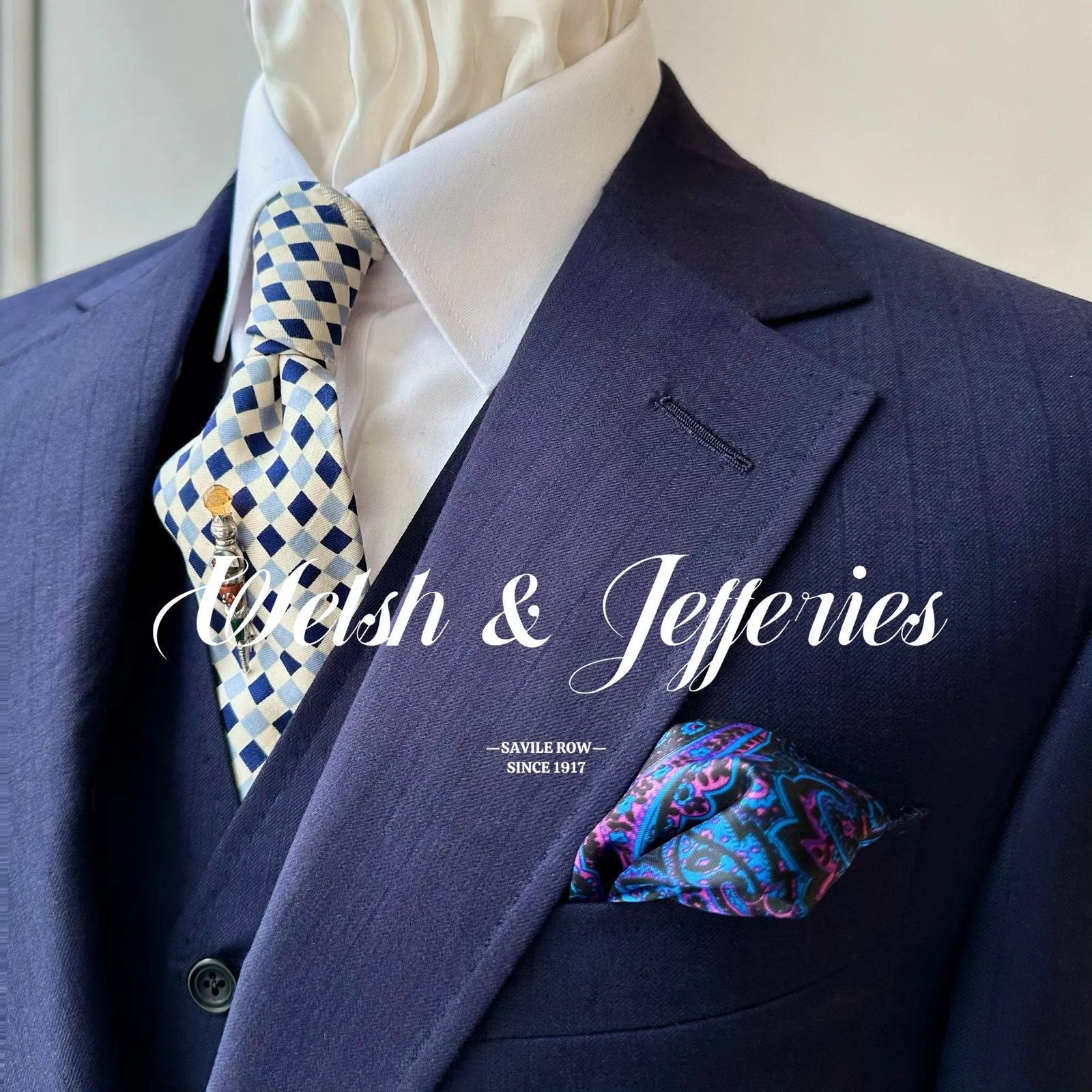 Close view of the lapel and breast pocket on a navy vicuña three-piece suit