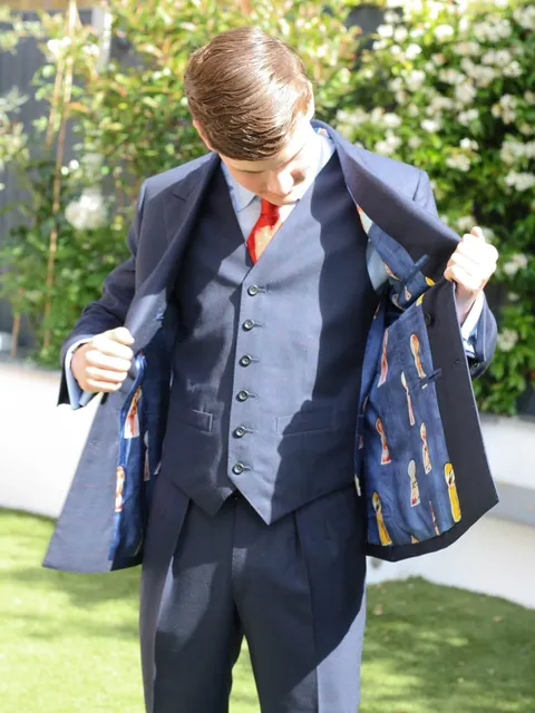 A graduation three-piece, lining on show