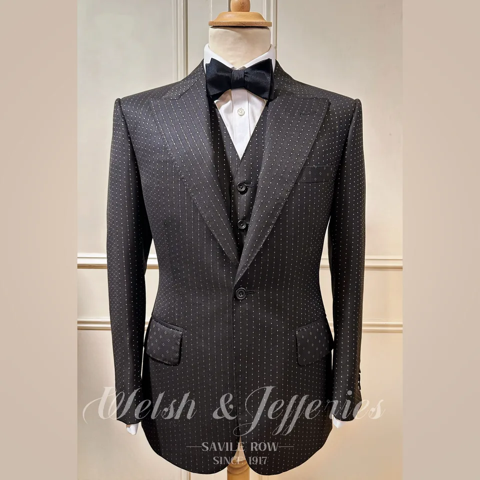 A midnight dinner suit combines gold-flecked Scabal cloth with a matching waistcoat and bow tie.