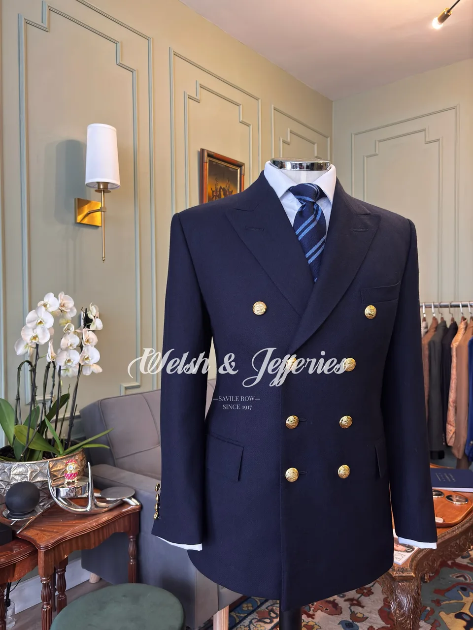 Midnight navy double-breasted blazer with broad peak lapels, gilt buttons and white cuff piping.