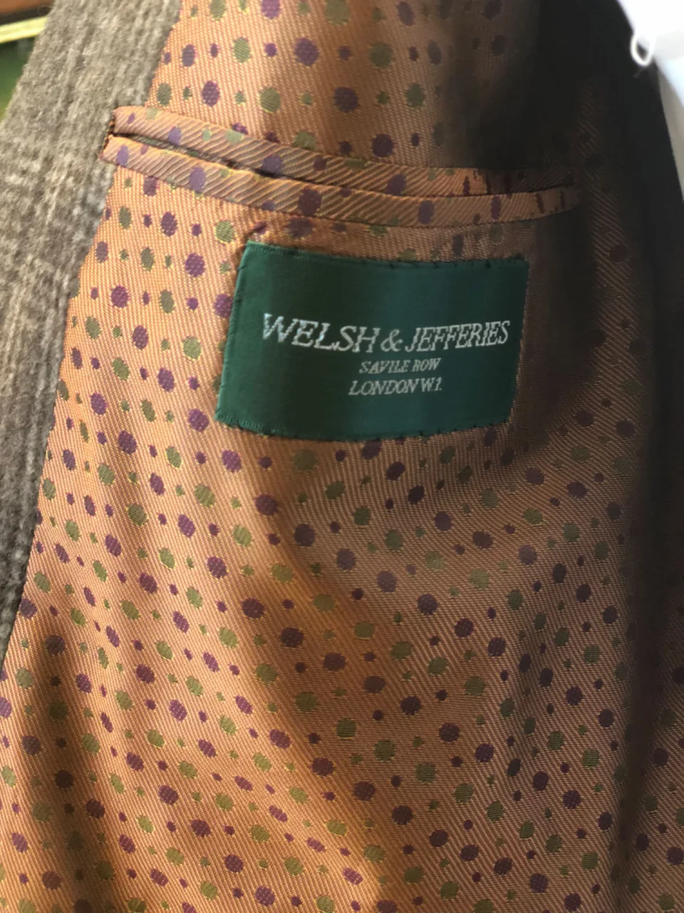 Archive view of the Welsh and Jefferies green woven house label, shown from the label close-up.