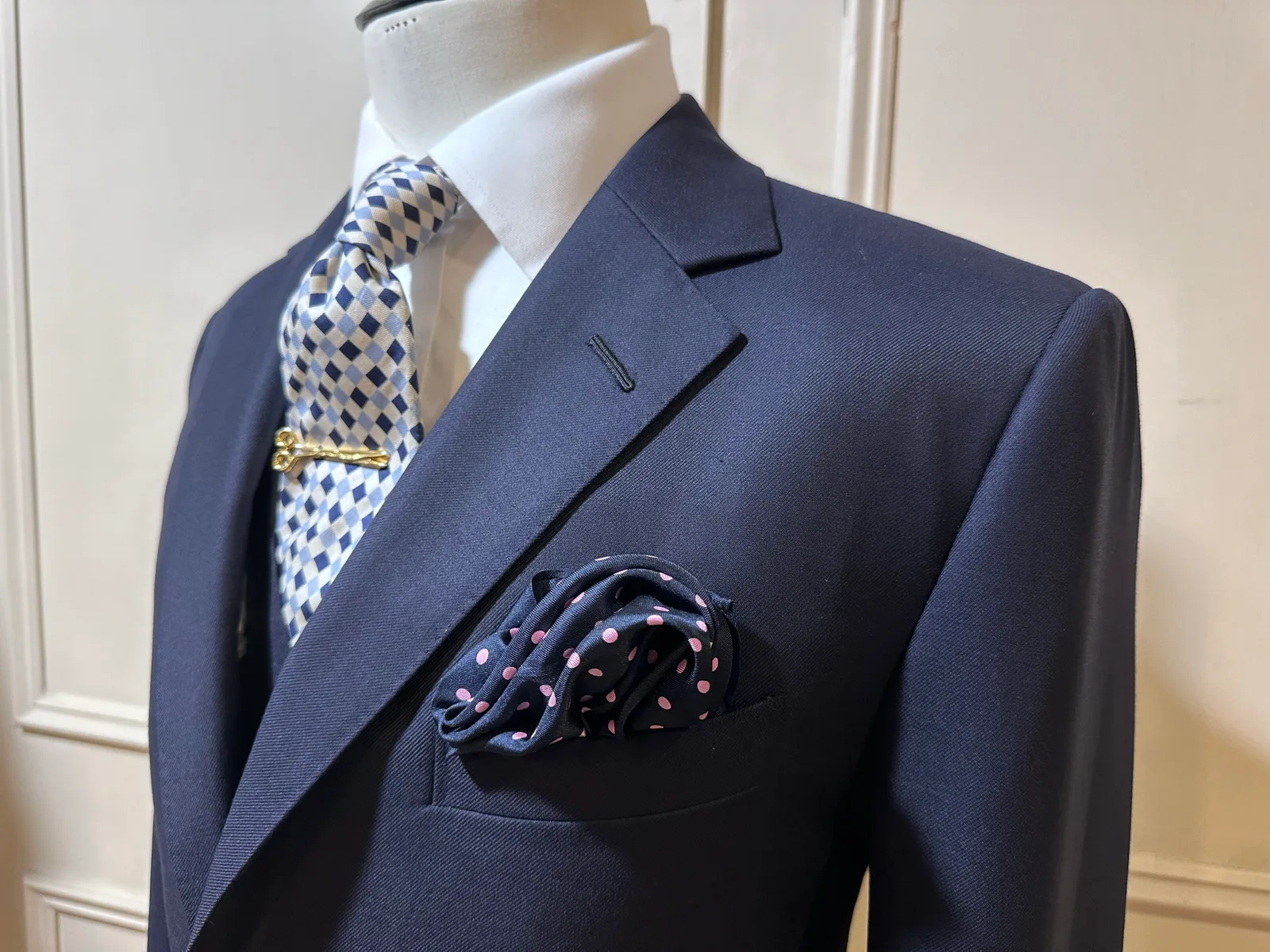 Close view of the midnight-navy suit’s notch lapel, breast welt and smooth worsted cloth.