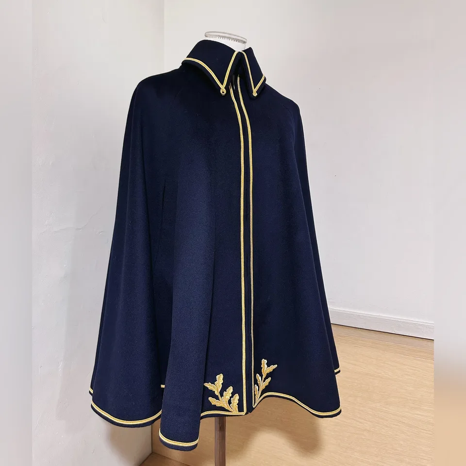 Front view of deep navy cavalry cape with gold piping.