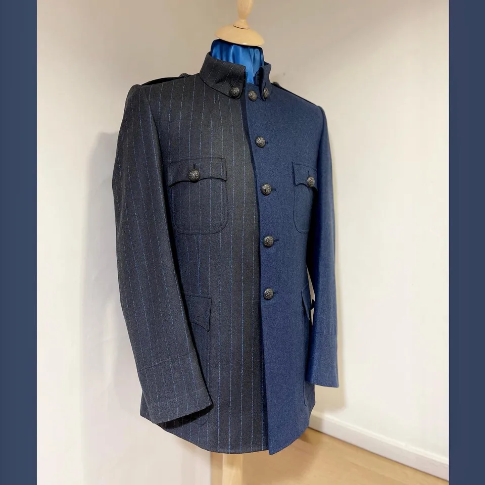 Military tunic divided between charcoal blue pinstripe and plain slate-blue wool.