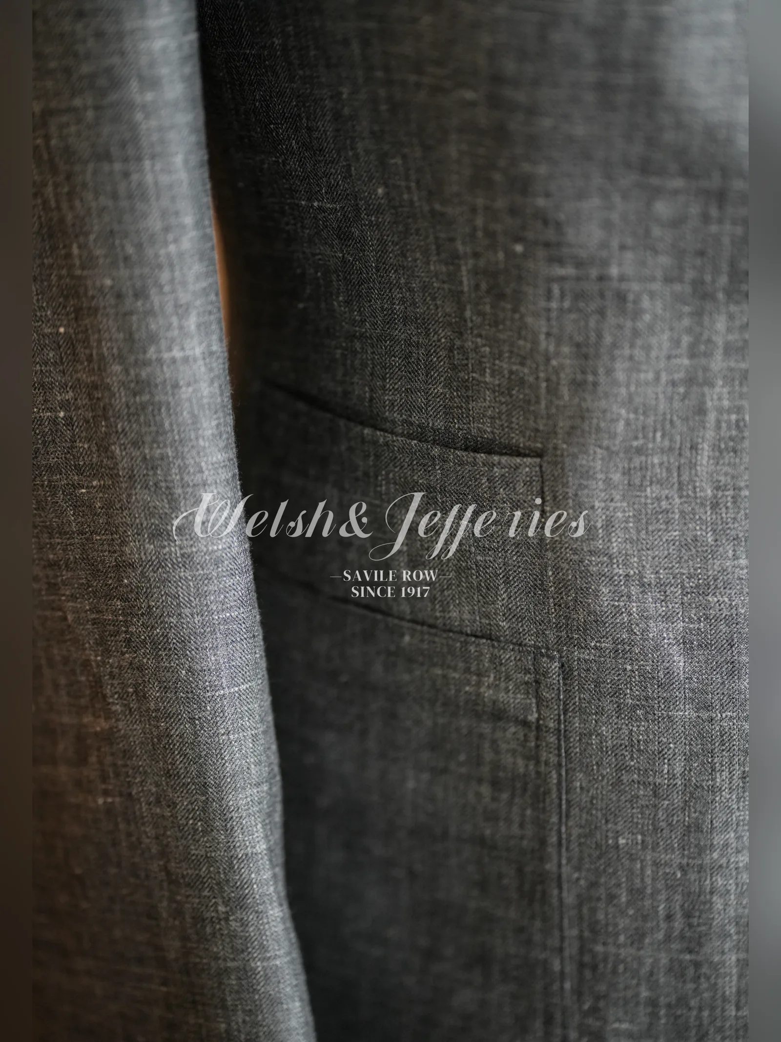 Close view of the pocket work on a moss-grey crosshatch summer jacket