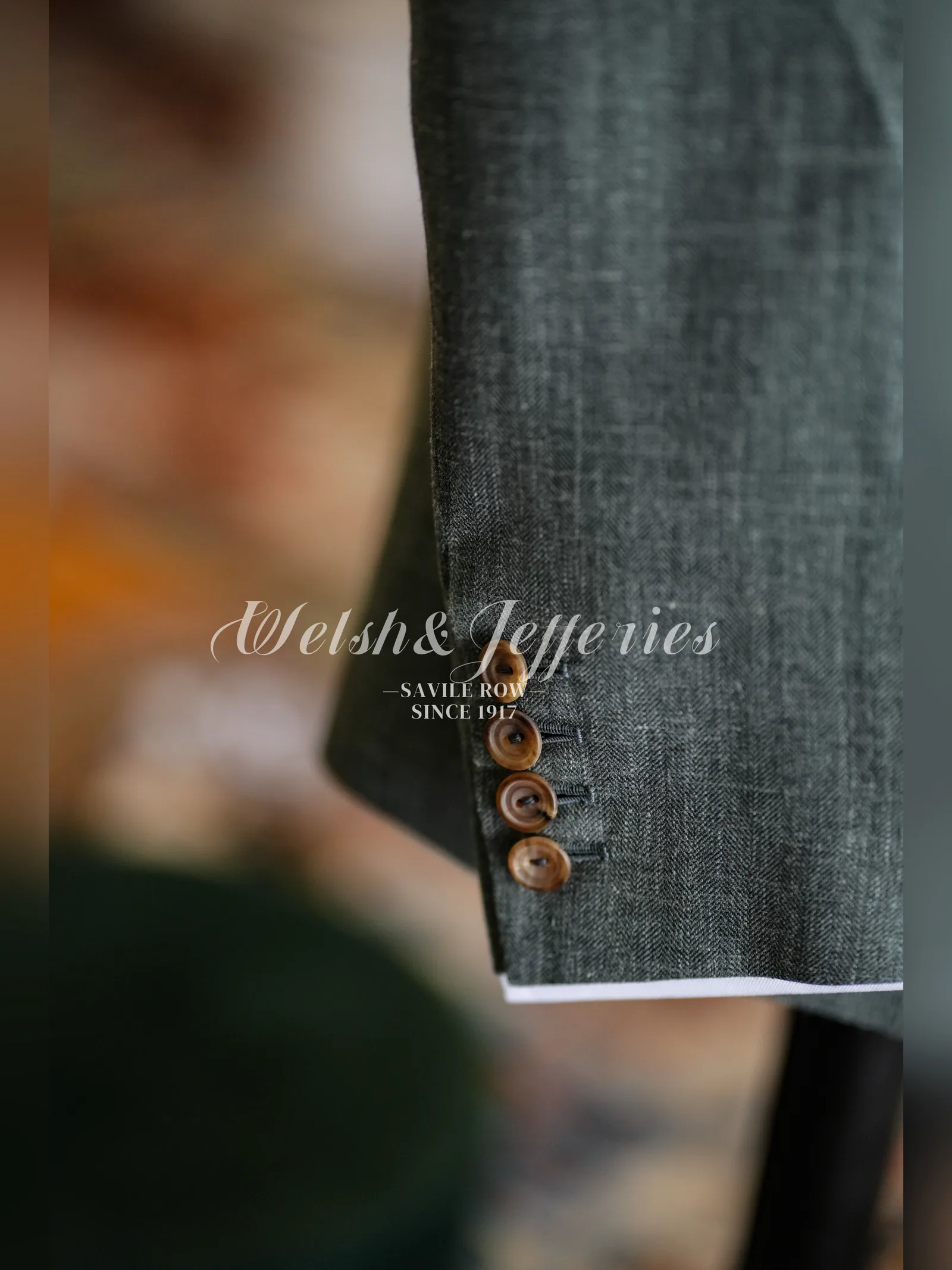 Close view of the working cuff on a moss-grey crosshatch summer jacket