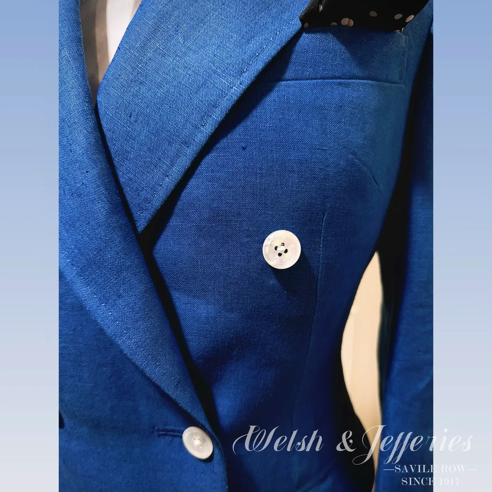 Waistcoat detail from electric-blue double-breasted ladies' three-piece suit.